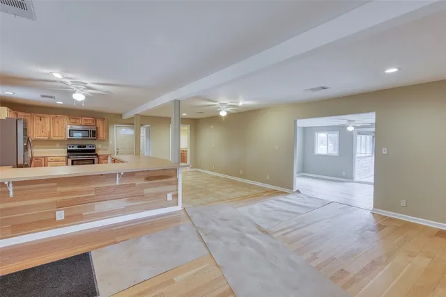 a view of kitchen with furniture and refrigerator
