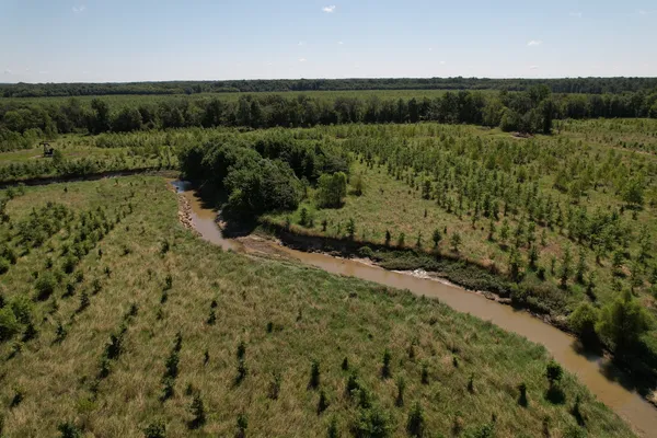 a view of a field with an ocean view