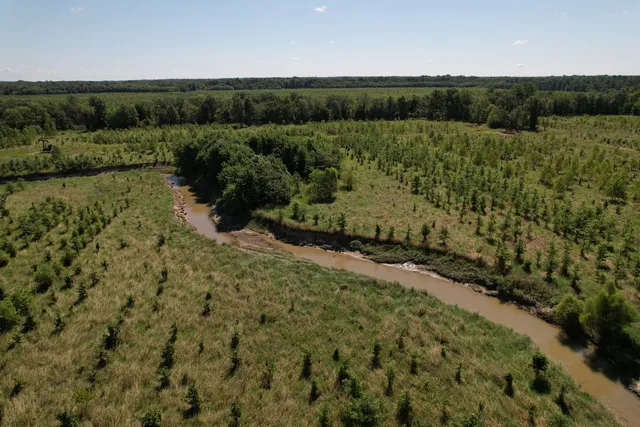 a view of a field with an ocean view