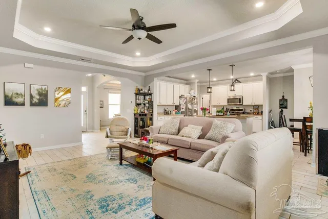 a living room with furniture and a dining table with kitchen view