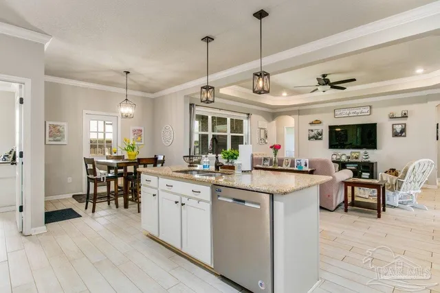 a open kitchen with stainless steel appliances granite countertop a stove and cabinets with wooden floor