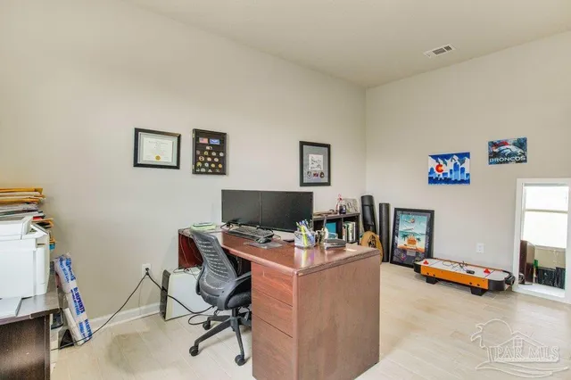 a view of a workspace with furniture and a bedroom