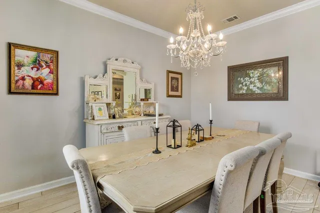 a dining room with furniture and chandelier
