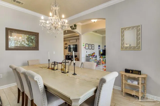a view of a dining room with furniture and chandelier