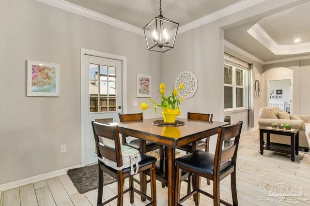 a view of a dining room with furniture and chandelier