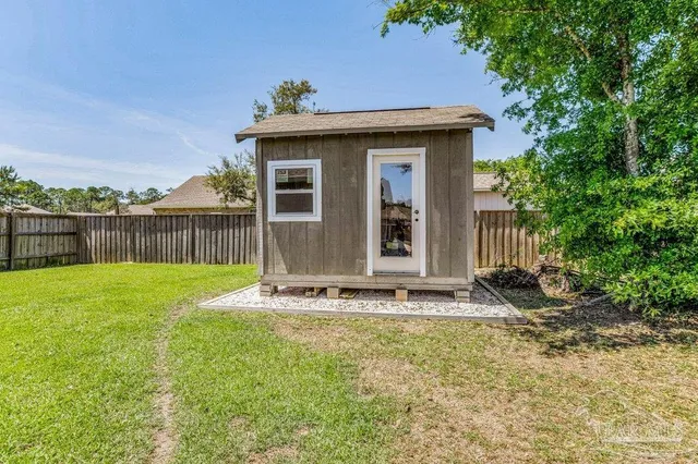 a view of a swimming pool with a garden and deck