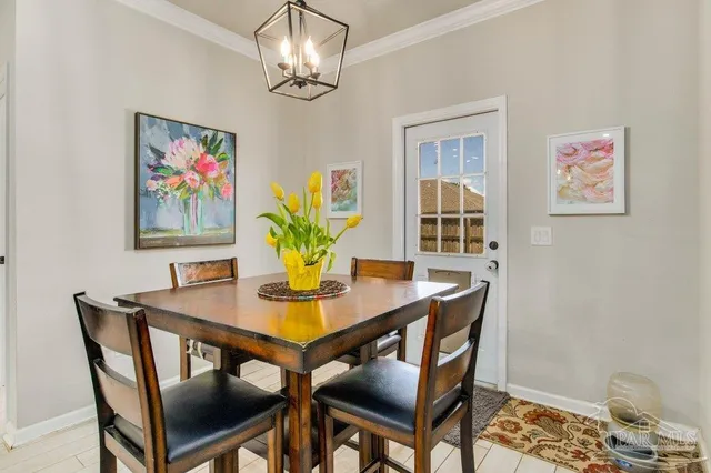 a view of a dining room with furniture wooden floor and a chandelier