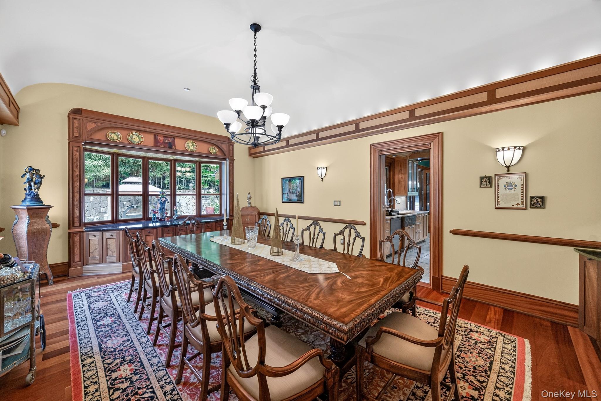23 Inningwood Road Ossining, NY 10562 - Photo 19 of 50 Formal dining area featuring hardwood flooring, a multi-pane bay window with intricate wood trim, and a decorative chandelier