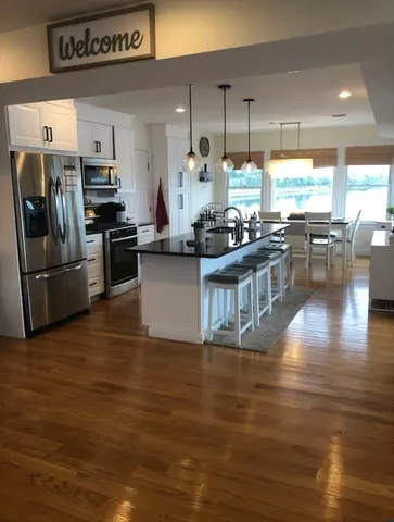 a kitchen with stainless steel appliances granite countertop a stove and a large refrigerator