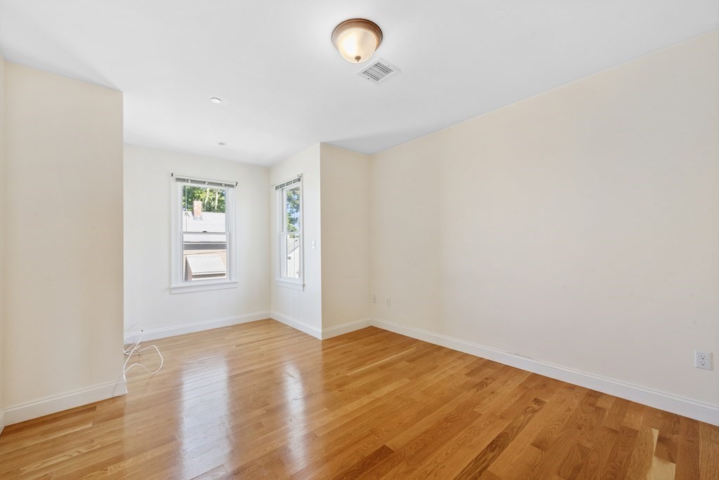 43 March Street, Unit 3 Salem, MA 01970 - Photo 9 of 10 an empty room with wooden floor and windows
