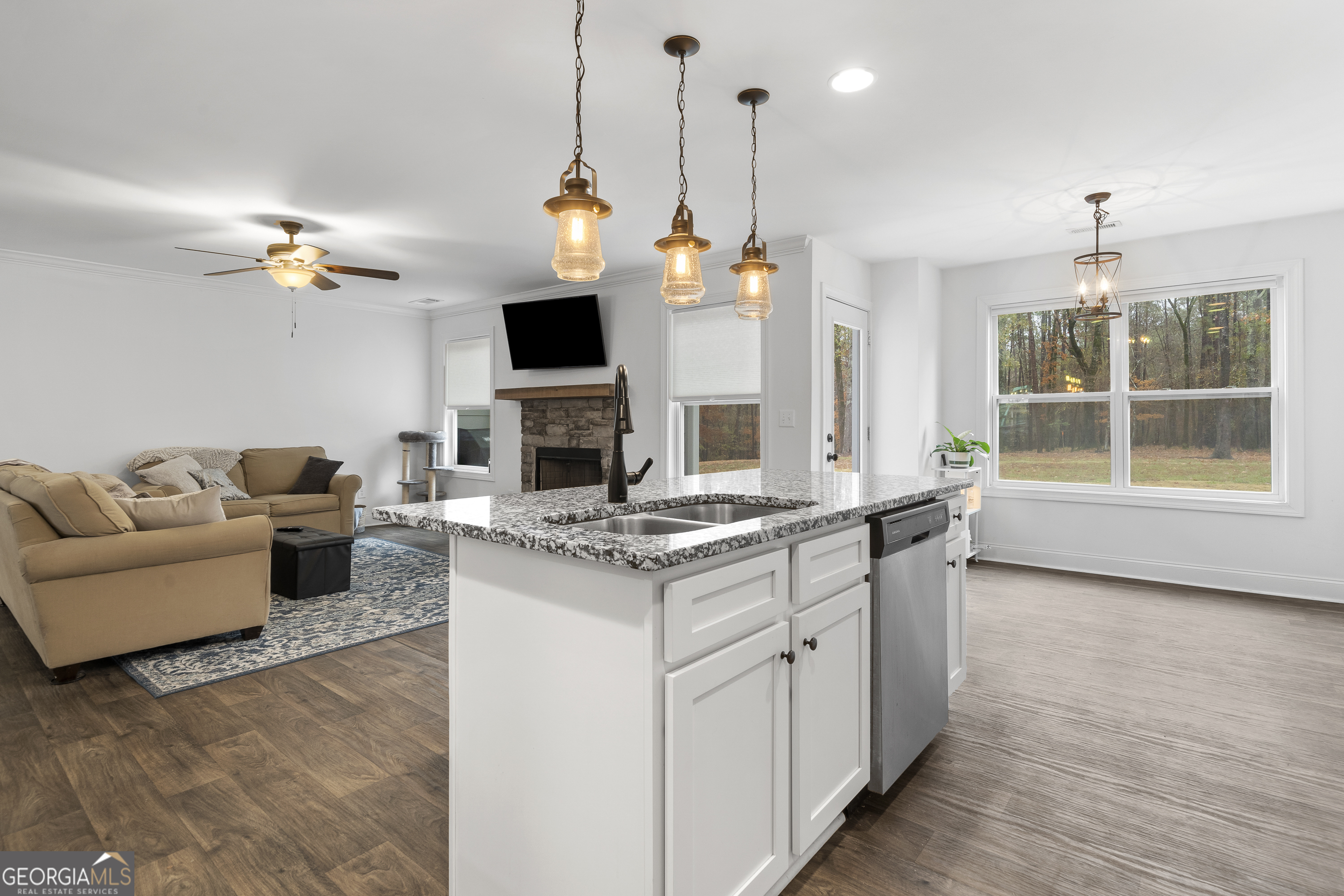 149 Willow Forest Road Milledgeville, GA 31061 - Photo 13 of 52 a living room with furniture a fireplace and a flat screen tv