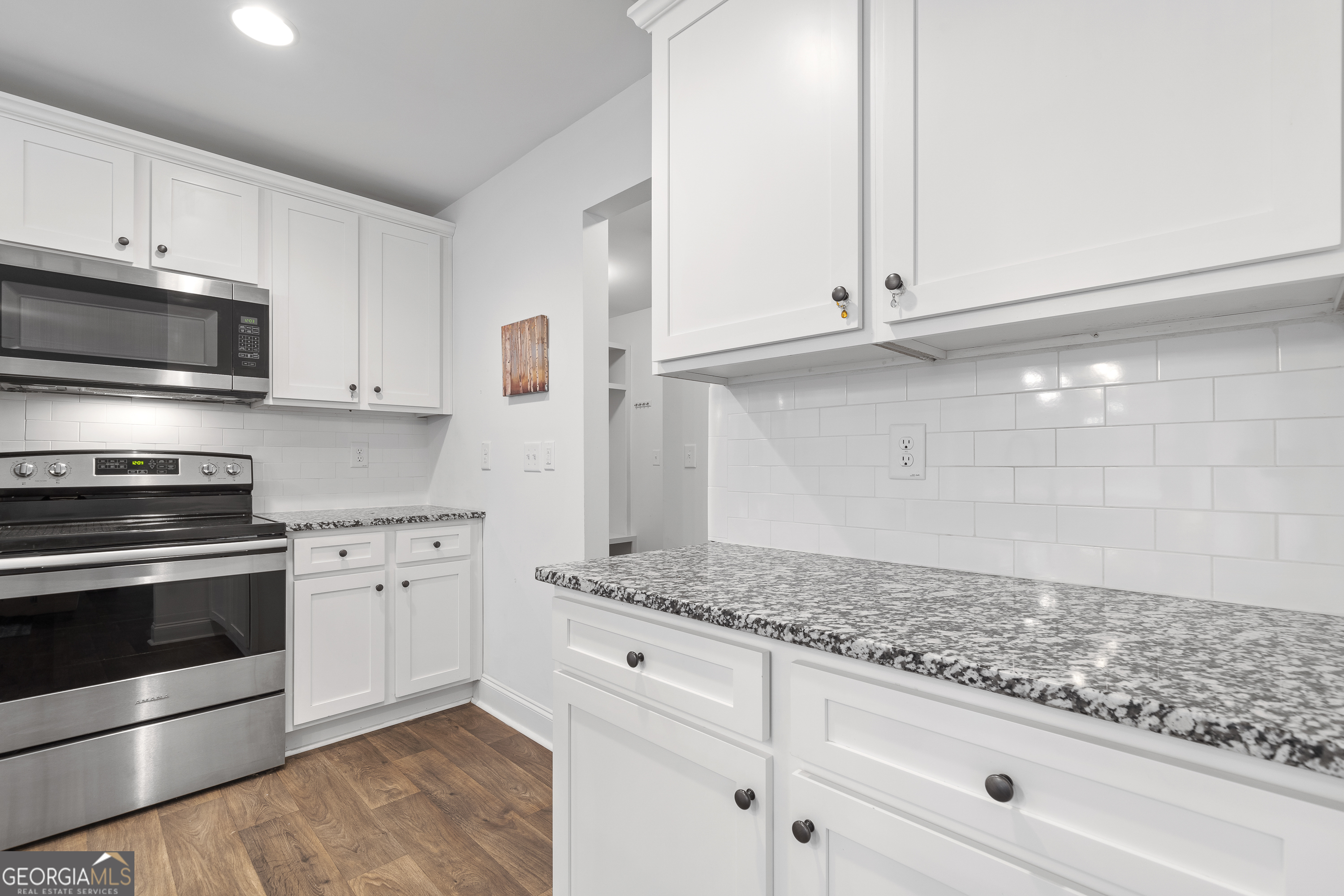 149 Willow Forest Road Milledgeville, GA 31061 - Photo 16 of 52 a kitchen with granite countertop white cabinets and stainless steel appliances