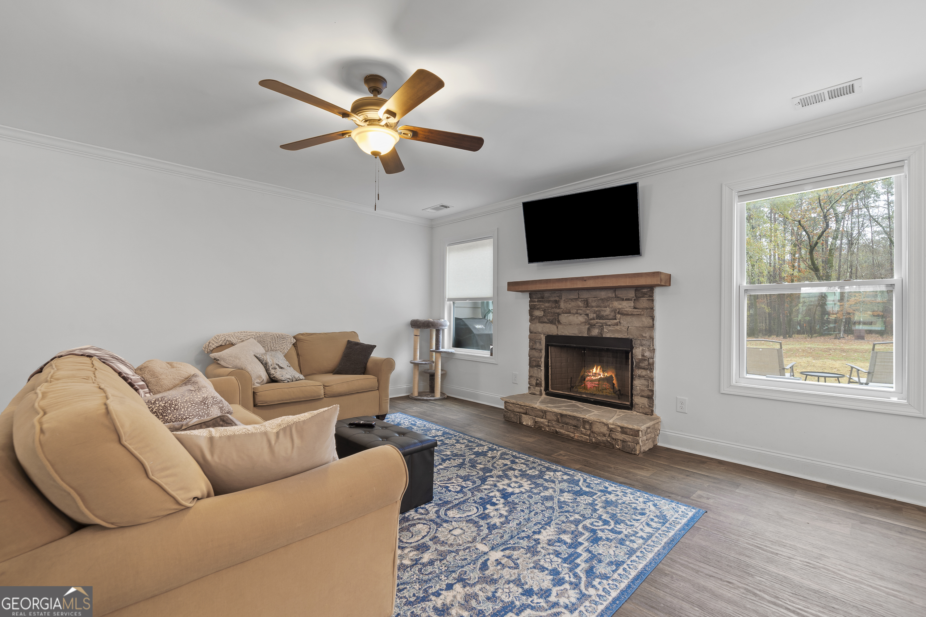 149 Willow Forest Road Milledgeville, GA 31061 - Photo 23 of 52 a living room with furniture a flat screen tv and a fireplace