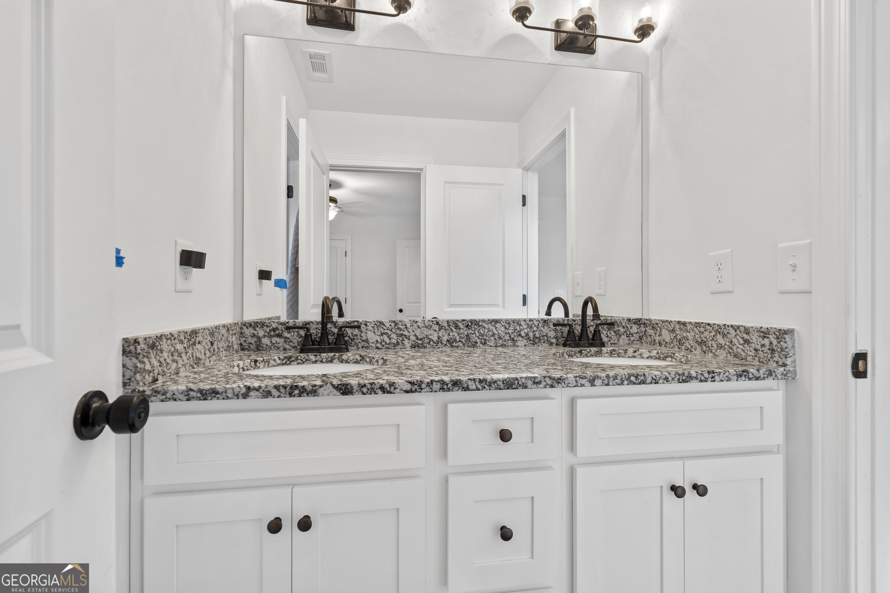 149 Willow Forest Road Milledgeville, GA 31061 - Photo 24 of 52 a bathroom with a granite countertop sink and a mirror