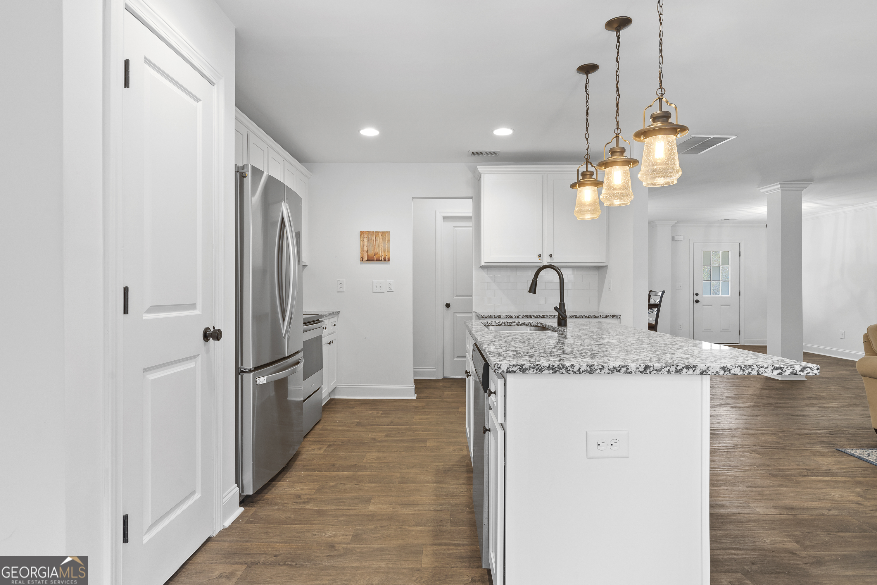 149 Willow Forest Road Milledgeville, GA 31061 - Photo 27 of 52 a kitchen with stainless steel appliances granite countertop a sink a refrigerator and a wooden floor