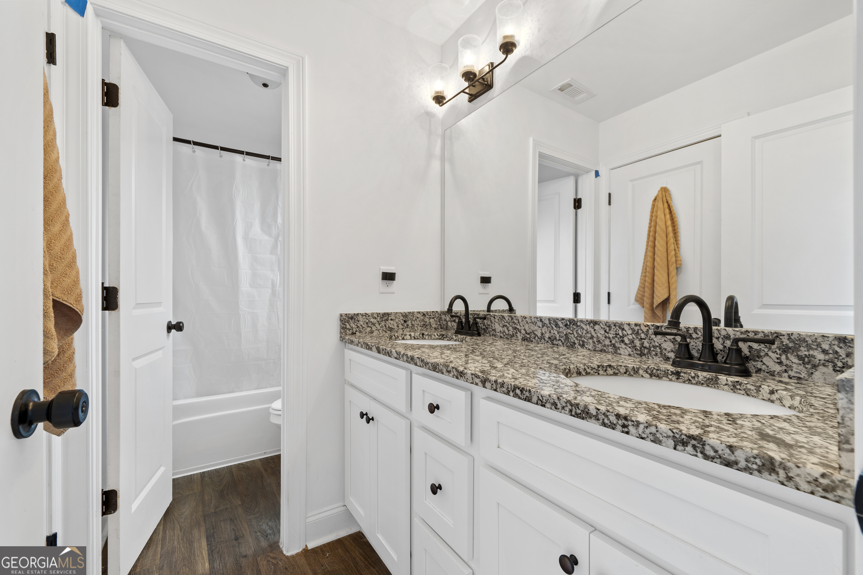 149 Willow Forest Road Milledgeville, GA 31061 - Photo 38 of 52 a bathroom with a granite countertop sink and a mirror