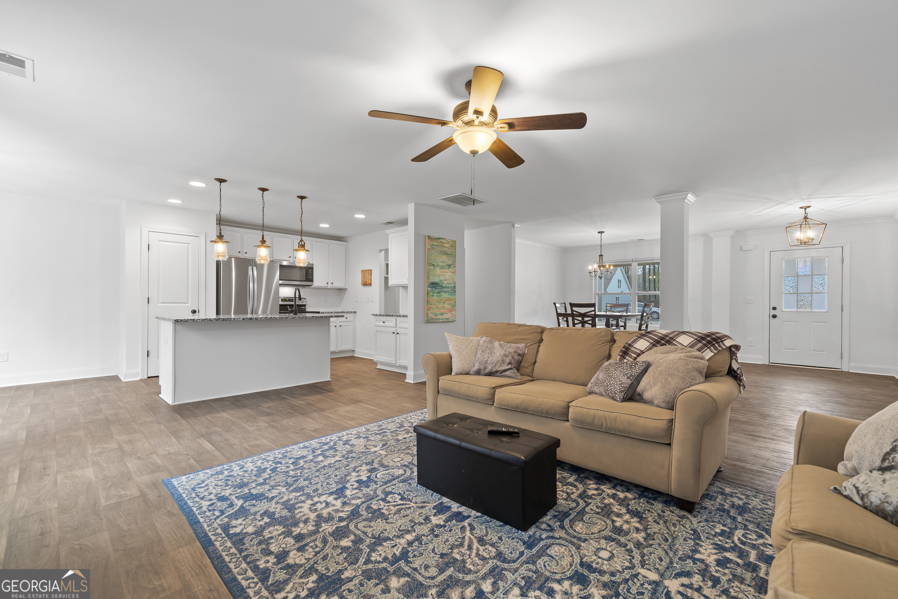 149 Willow Forest Road Milledgeville, GA 31061 - Photo 6 of 52 a living room with furniture kitchen view and a chandelier