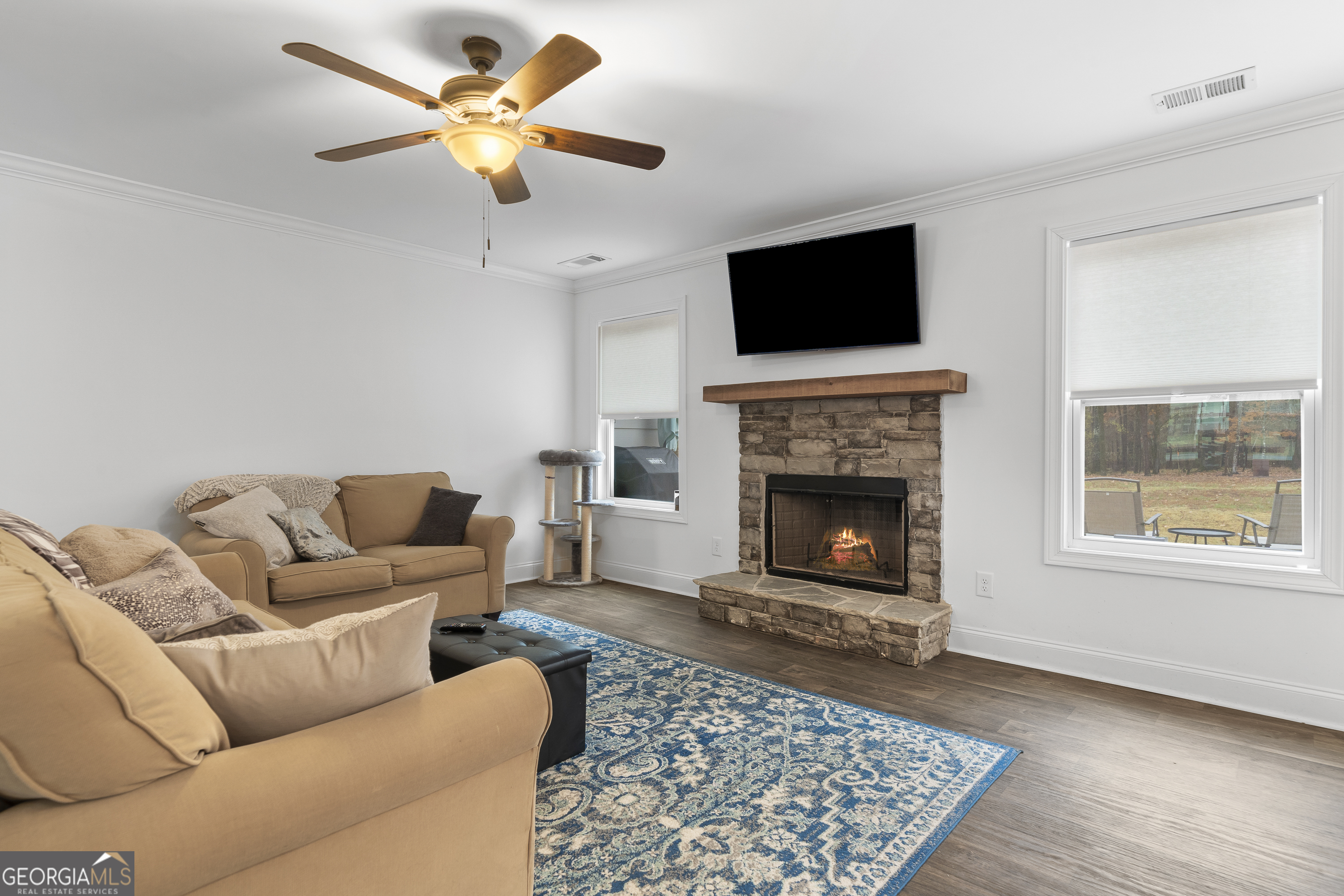 149 Willow Forest Road Milledgeville, GA 31061 - Photo 7 of 52 a living room with furniture a flat screen tv and a fireplace