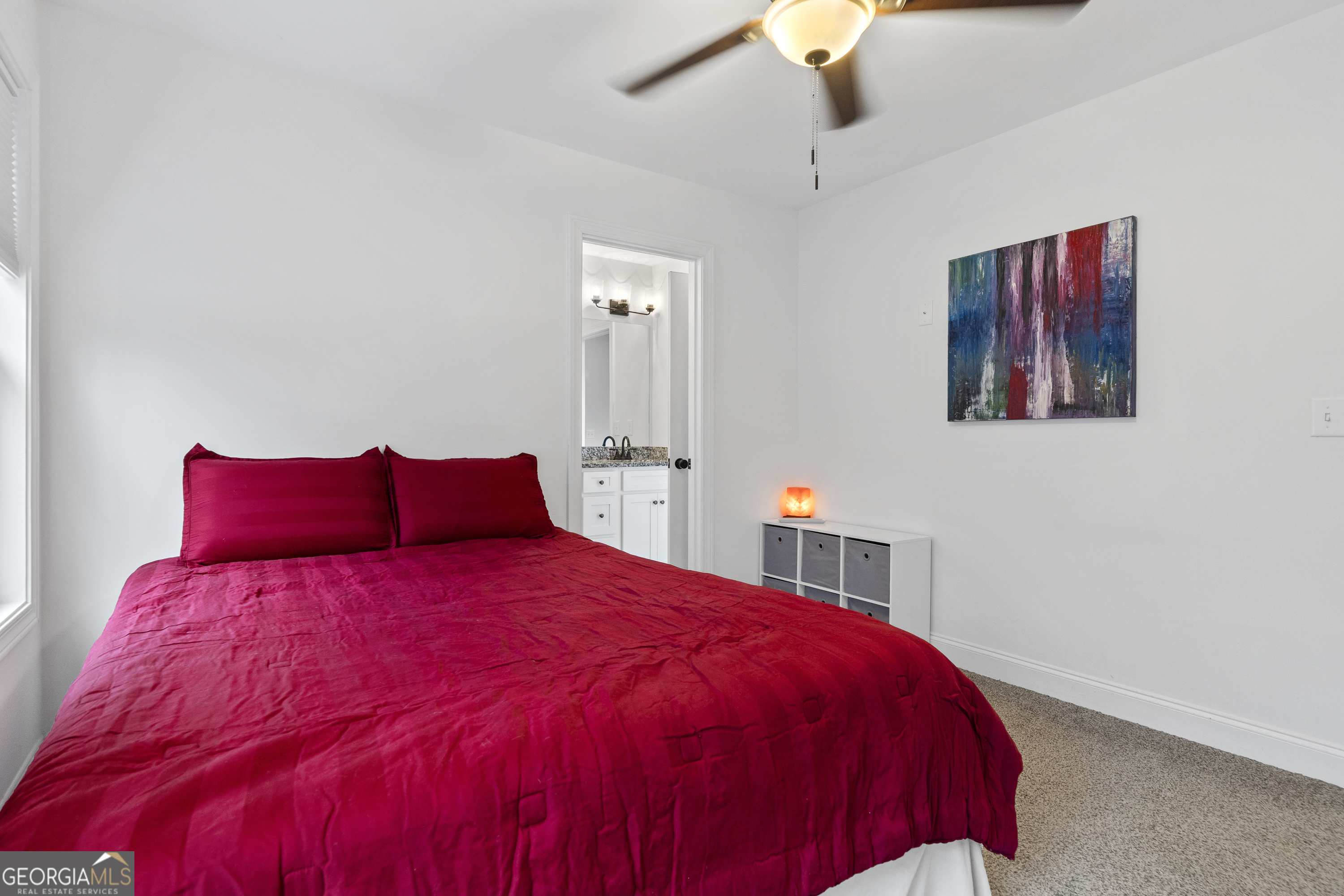 149 Willow Forest Road Milledgeville, GA 31061 - Photo 10 of 52 a bedroom with a large bed and a chandelier