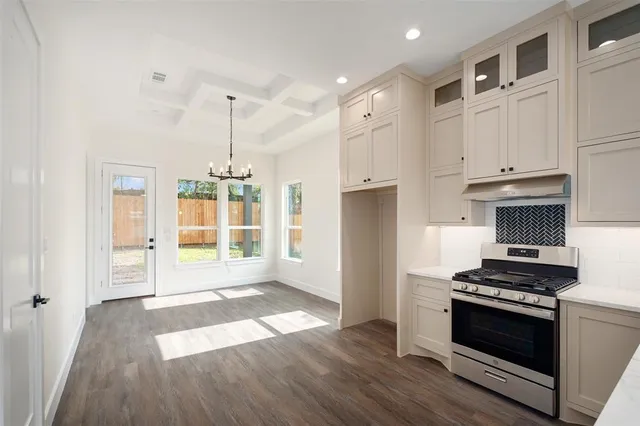 a kitchen with granite countertop a stove and a refrigerator