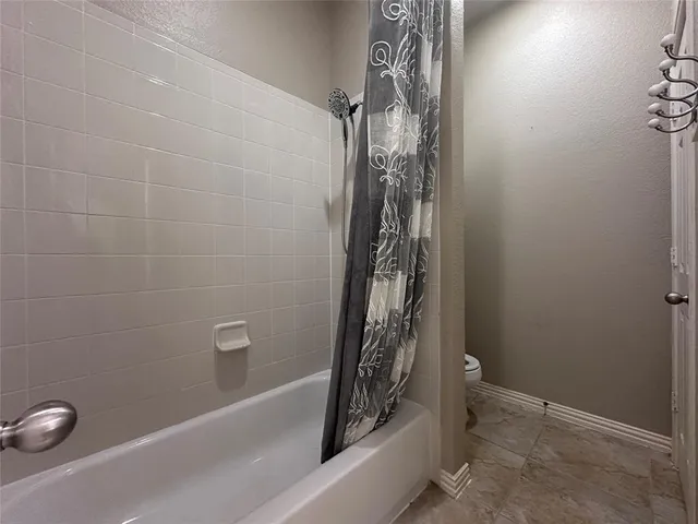 a bathroom with a bathtub and shower
