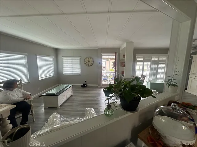 a living room with furniture and flowers