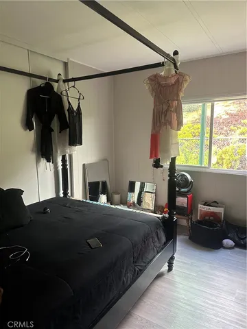 a bedroom with a bed window and walk in closet