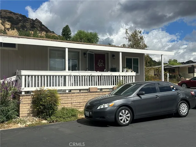 a view of a car parked in front of a house