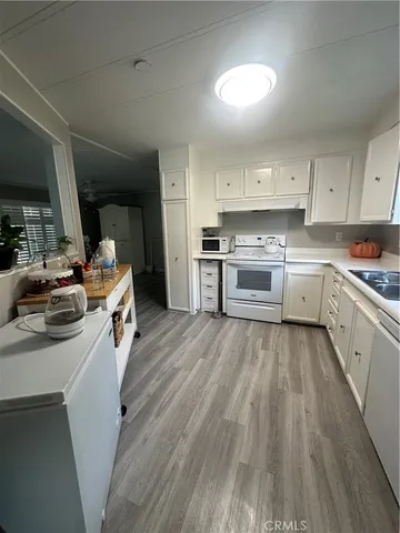 a kitchen with a stove a sink and a refrigerator