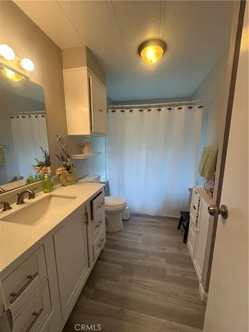 a bathroom with a double vanity sink mirror and shower