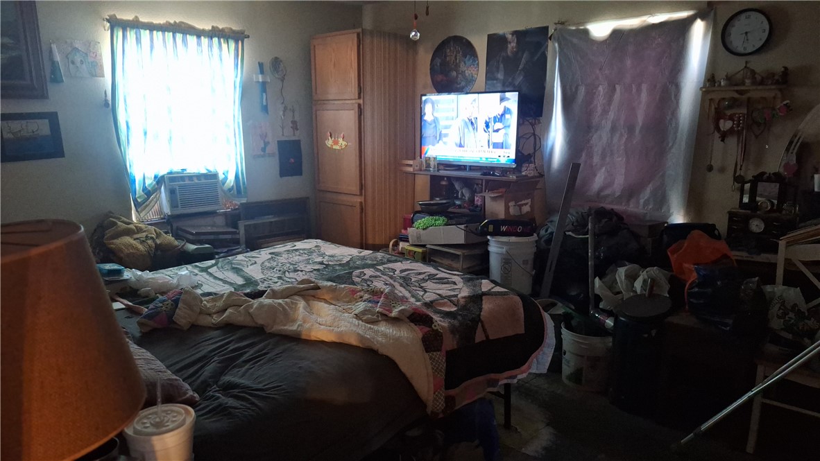 3571 Winding Road Hearne, TX 77859 - Photo 14 of 14 a bedroom with a bed a television and a window