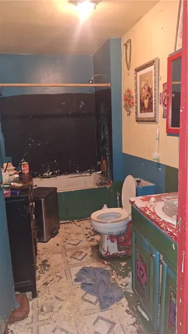 a bedroom with a bed and a mirror