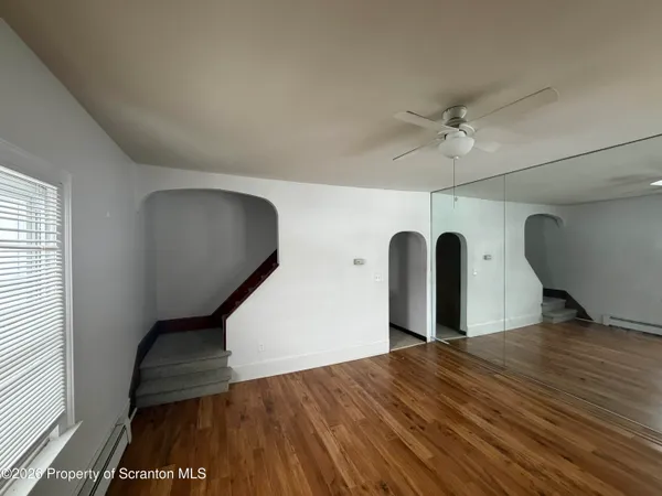 a view of a livingroom with wooden floor