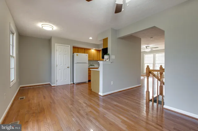 a view of empty room with wooden floor