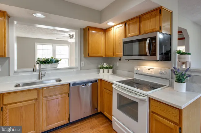 a kitchen with a sink stove and microwave