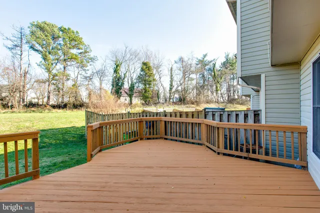 a view of a balcony with wooden floor and fence