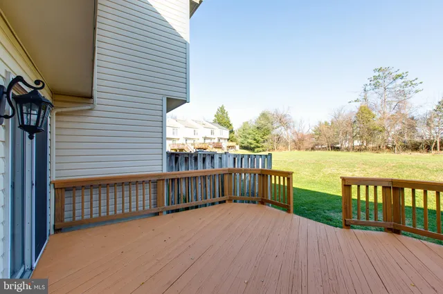 a view of a balcony with wooden floor and fence