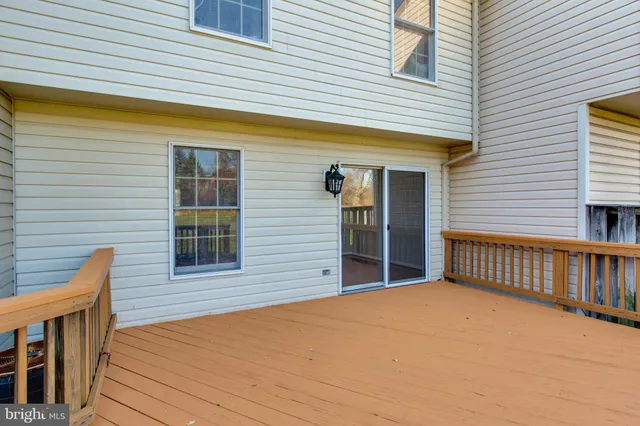 a view of a house with wooden deck