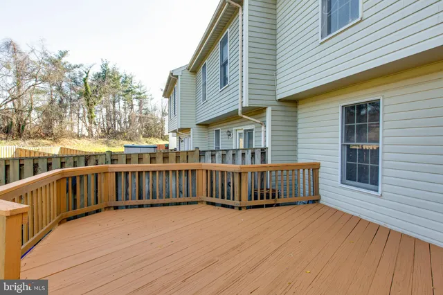 a view of a house with a wooden deck
