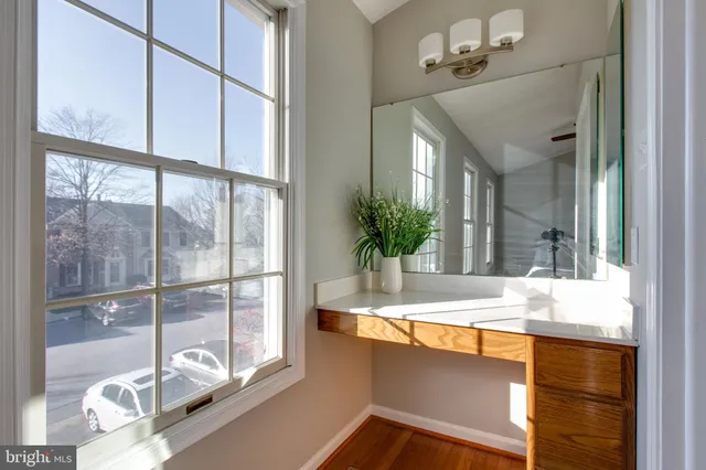 a room with a large window and chandelier