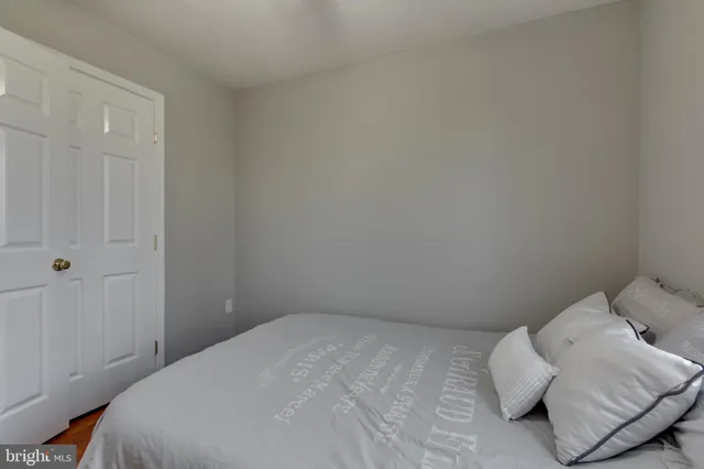 a bedroom with a bed and pillows