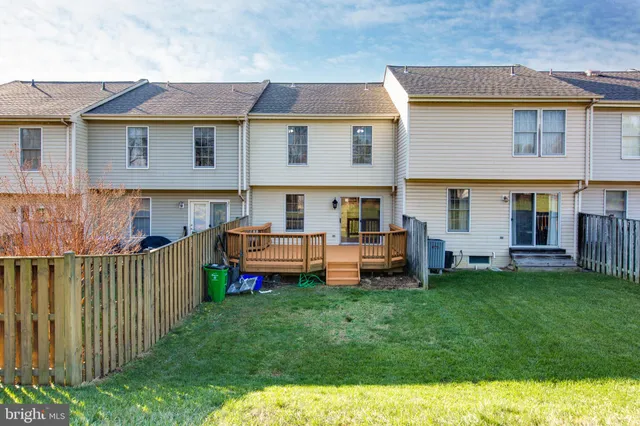 a front view of a house with a yard and deck