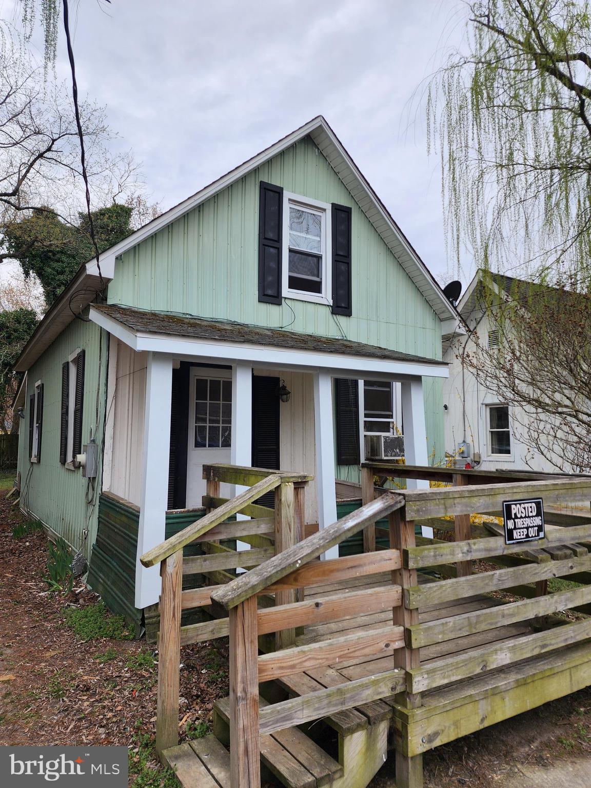 a front view of a house with a table and chairs