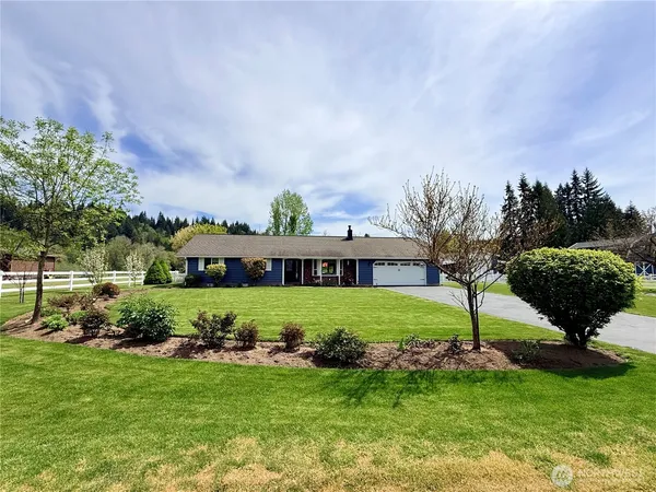 a view of a house with a backyard and a garden