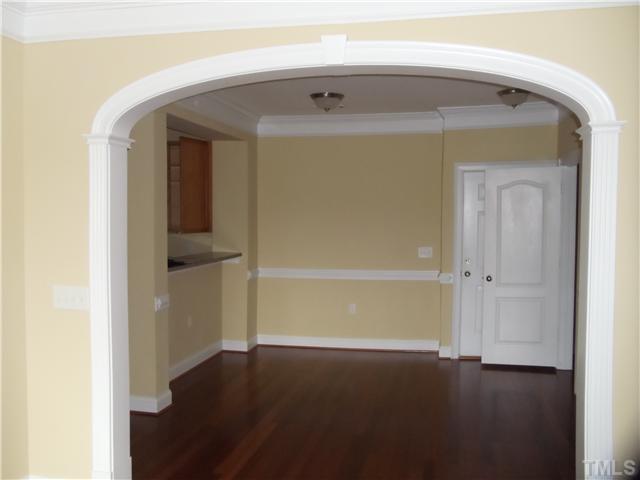 3811 Lunceston Way, Unit 305 Raleigh, NC 27613 - Photo 6 of 25 Receiving area, front entrance, note solid surface bar overhang, arched openings & heavy mouldings.