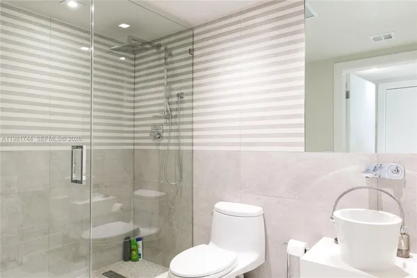 a bathroom with a toilet sink and shower