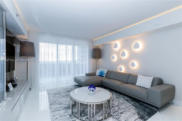 a living room with furniture and a flat screen tv