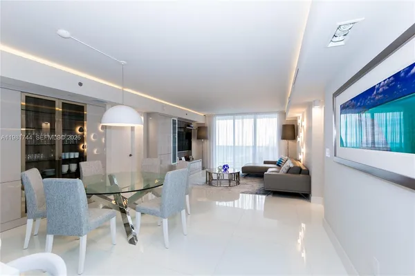 a living room with furniture and large windows