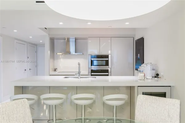 a kitchen with stainless steel appliances granite countertop a sink and a stove