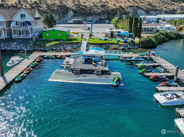 a view of a lake with table and chairs